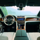 The interior of a Bentley Bentayga EWB, in green and tan leather and glossy wood.